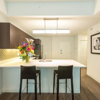 kitchen with wooden cabinets and white counter tops at midtown park apartments 